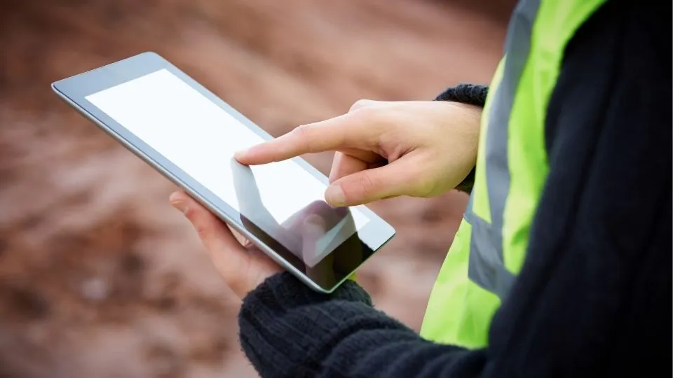 Technician views water treatment software on a tablet.