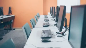 Concurrent user licensing shown by a row of shared computer workstations in an office.
